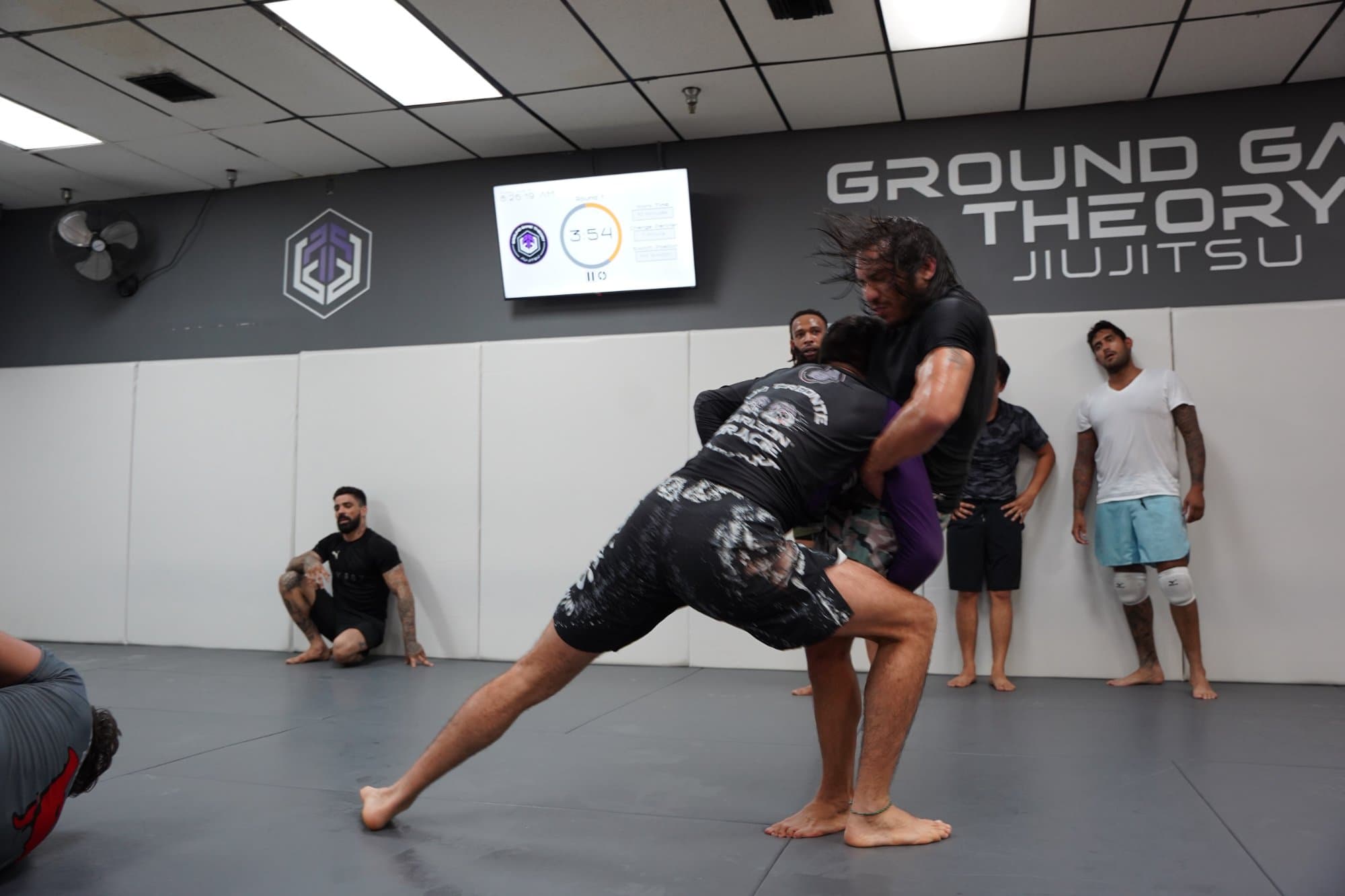 CLA Jiu Jitsu Training at Ground Game Theory Miami Two athletes practicing live no-gi wrestling during a jiu jitsu class at Ground Game Theory in Miami, Florida.